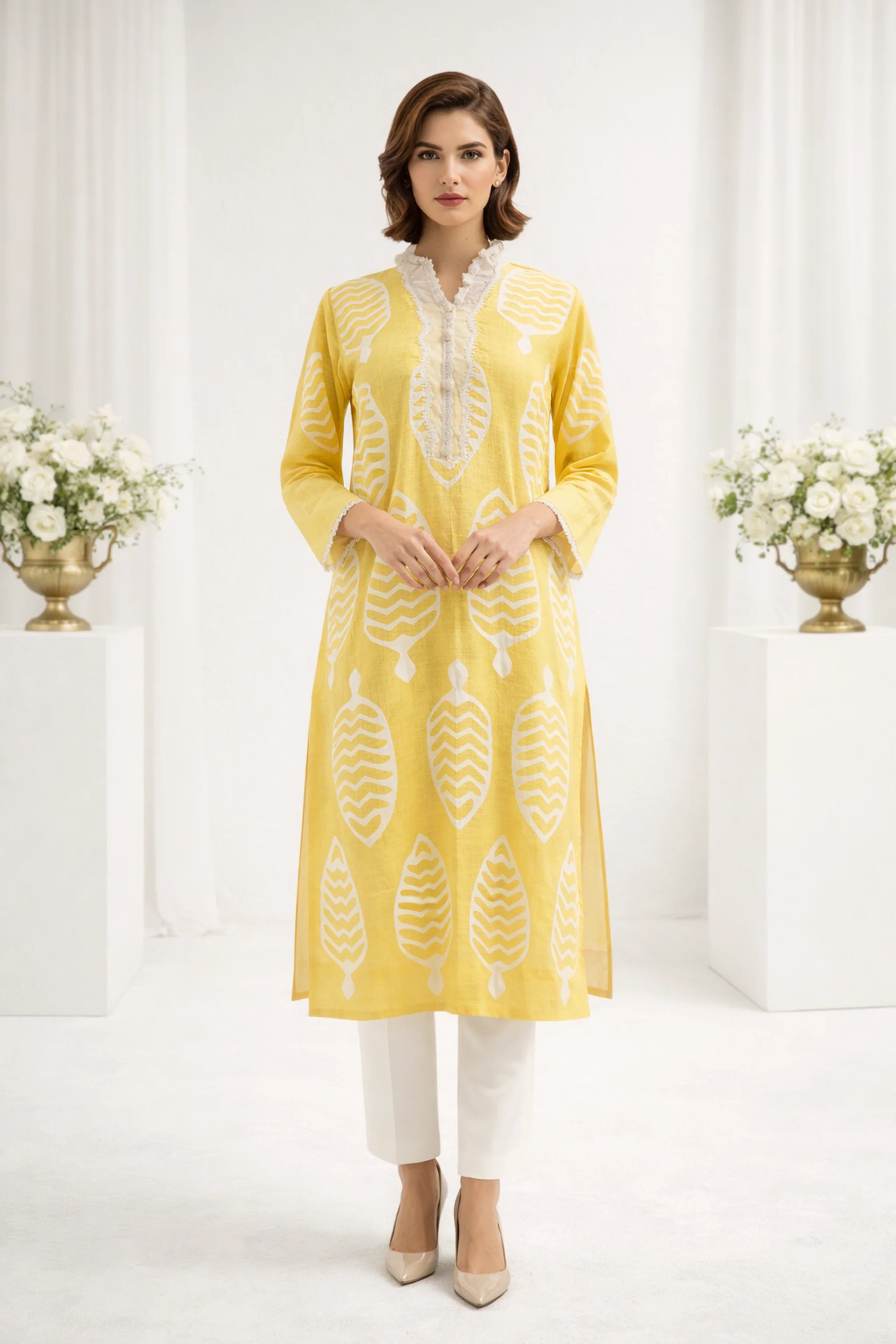 Close-up_of_Apachi_yellow_premium_lawn_shirt_with_ralli_work_and_lace_details.
