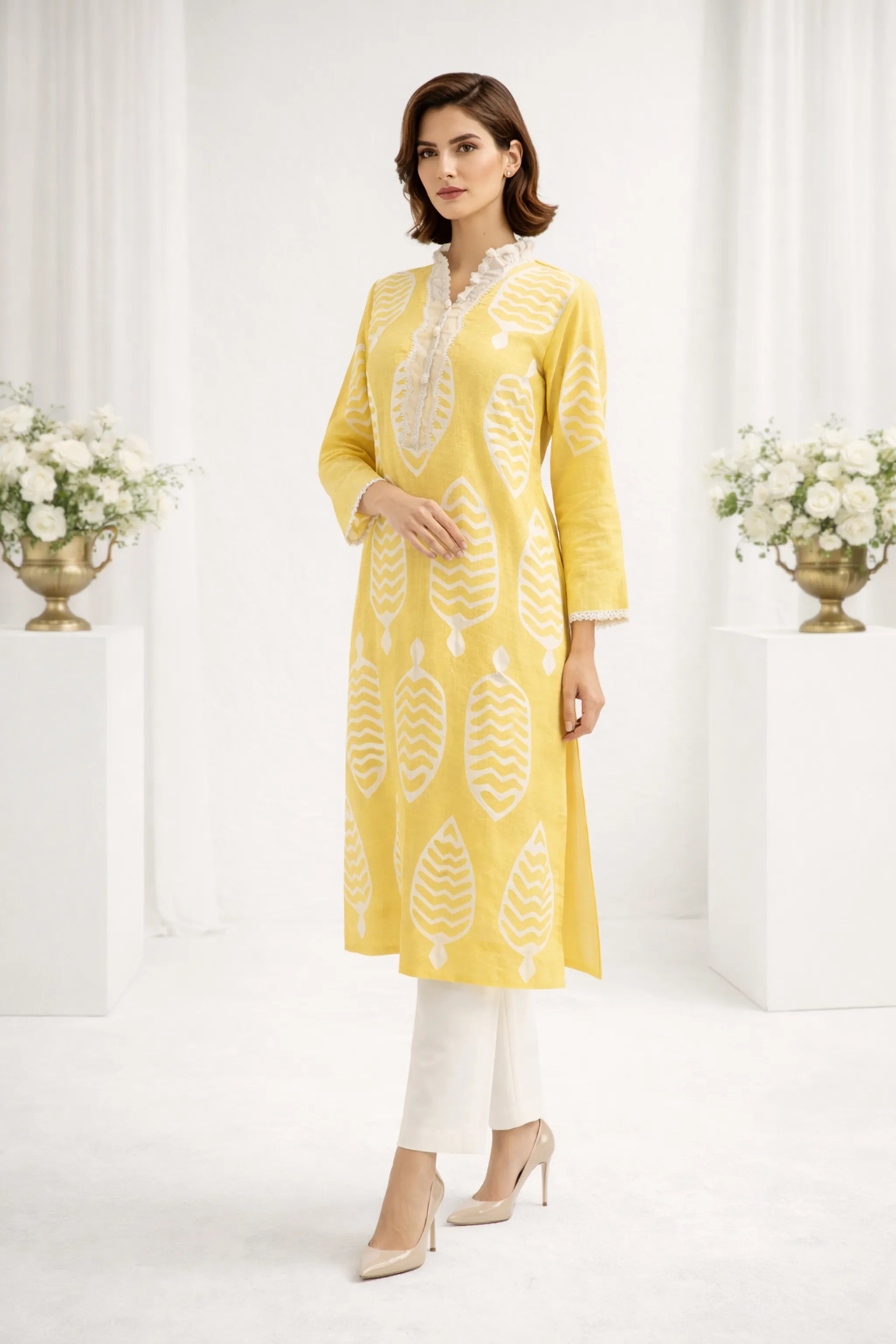 Close-up_of_Apachi_yellow_premium_lawn_shirt_with_ralli_work_and_lace_details.