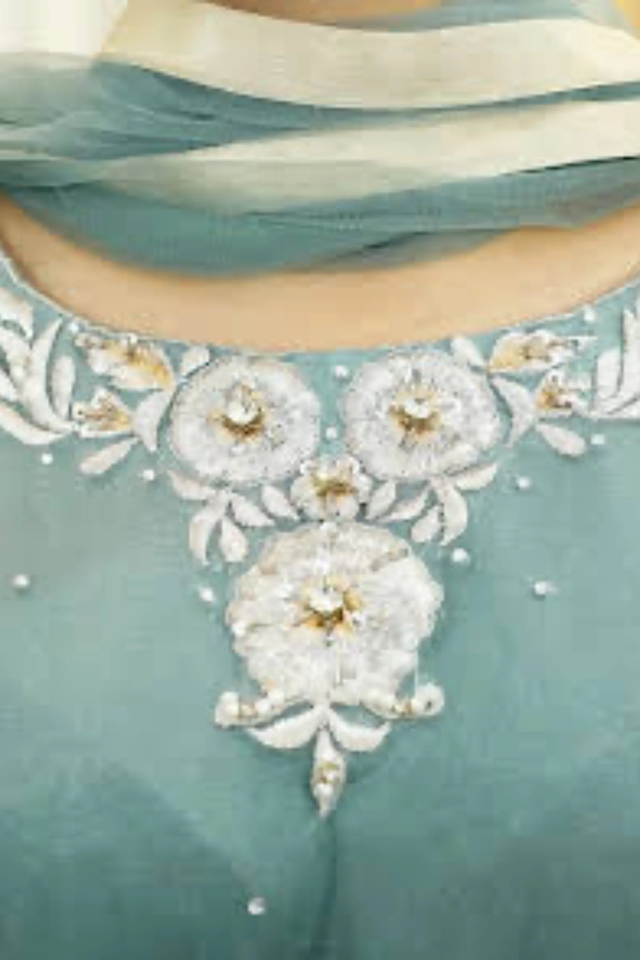 Close-up of white and silver floral embroidery with beadwork on pastel teal net frock neckline and sleeves
