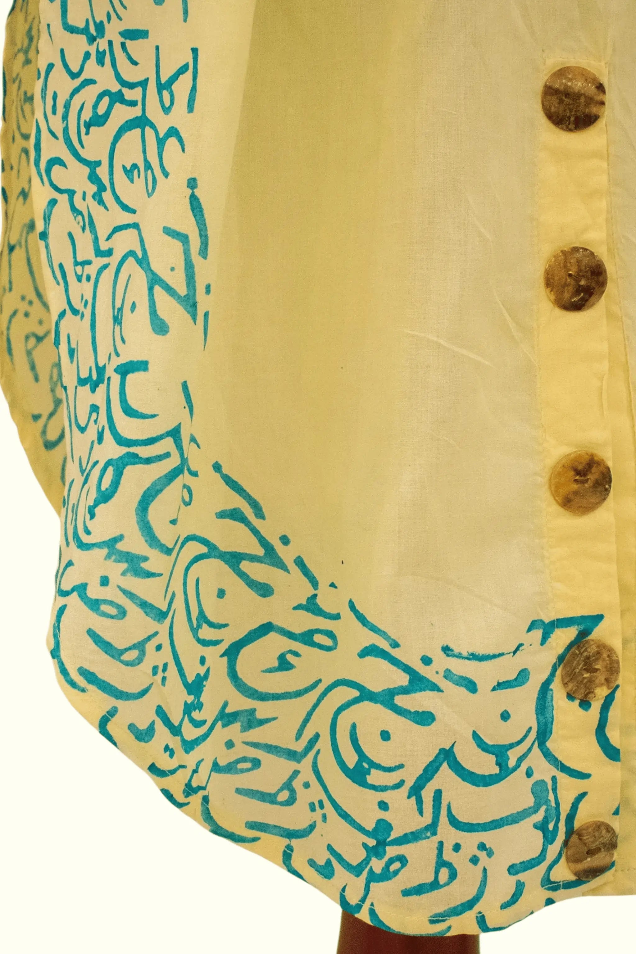 Gold Sand premium Bareeze lawn fabric close-up with calligraphy motifs