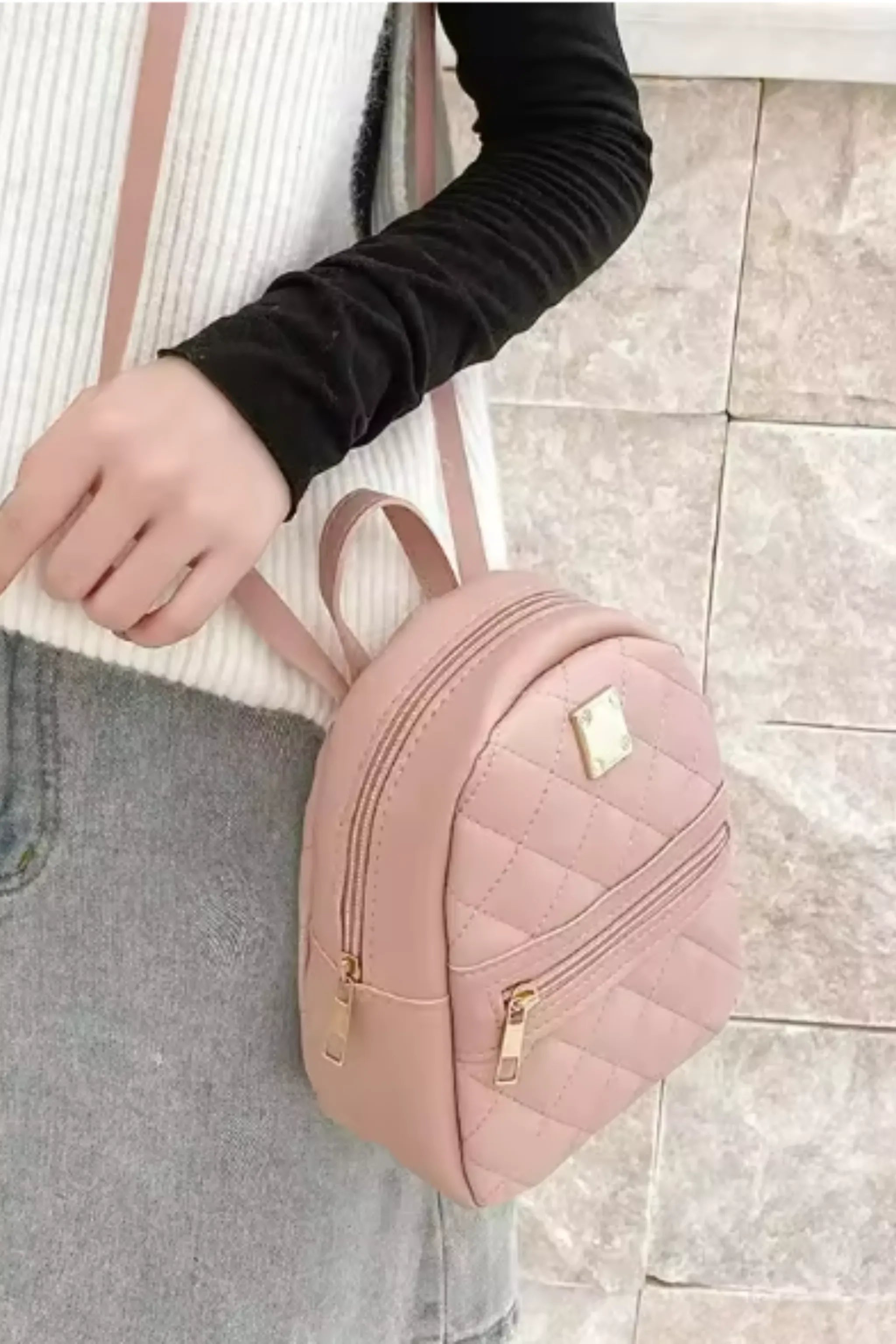 Interior view of plaid mini backpack with multiple compartments and spacious storage