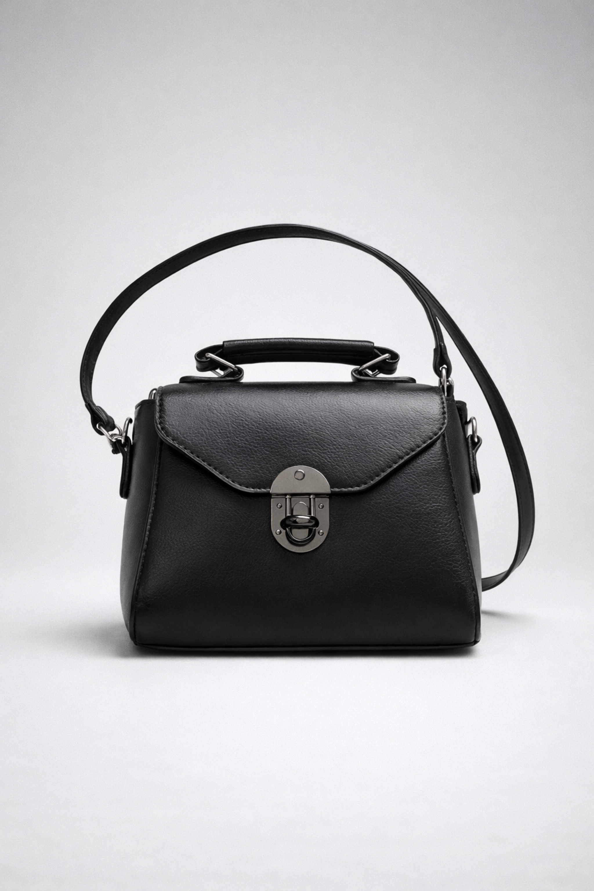 “Vintage black mini square PU leather bag with buckle closure and top handle”